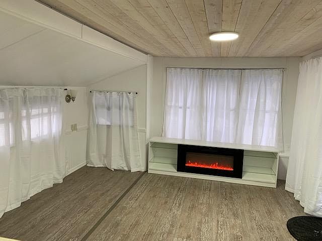 Living room with new fireplace TV stand for heat source. Flame works with heat or no heat.