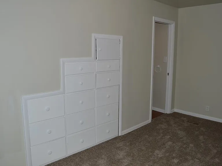 Dresser in the wall, under the stairs