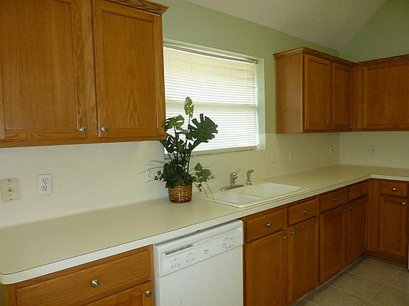 Note the lovely oak finished cabinetry and tiled flooring