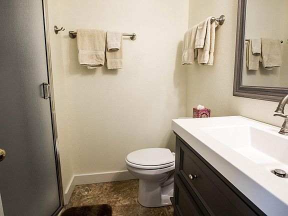 Bathroom with large shower with seat. Bathroom and kitchenette divide the siting room from bedroom.
