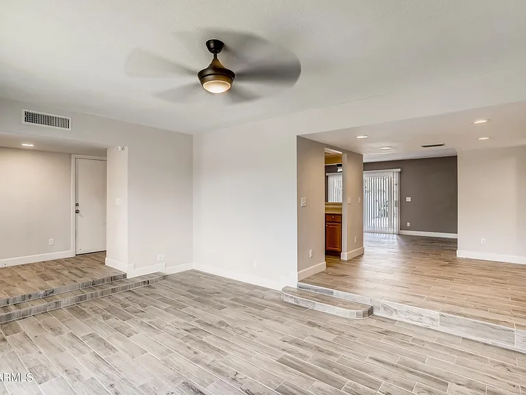 Large south-facing living room with high ceilings. Step up to the dining area or entryway & garage.