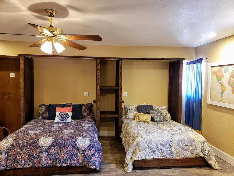 Bedroom 1: Mother-in-law Suite 
This is a huge room with two beds, a private entry, a private bathroom, a private patio, a mini kitchenette area, a tv, and a fireplace. We use this room as a guest room, and it's basically a tiny house.