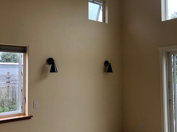The bedroom with reading lights above the bed.