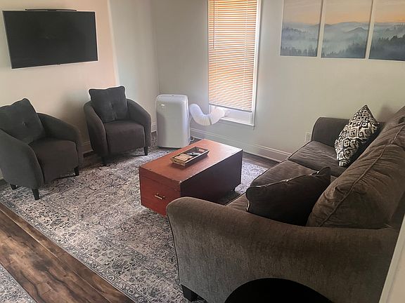 Living room with portable AC unit.