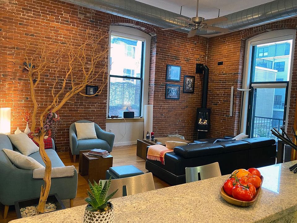Living room with 12 ft. ceilings, 10 ft. windows and modern gas fire place.