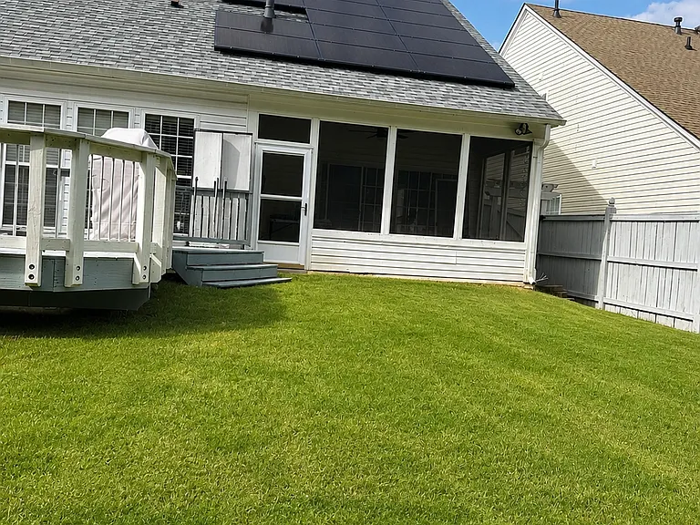 Fully fenced backyard with a spacious deck and energy-saving solar panels