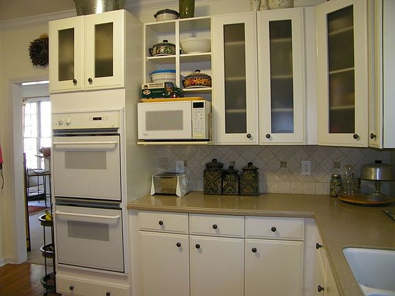 corian counter, tumbled marble backsplash, & modern cabinets