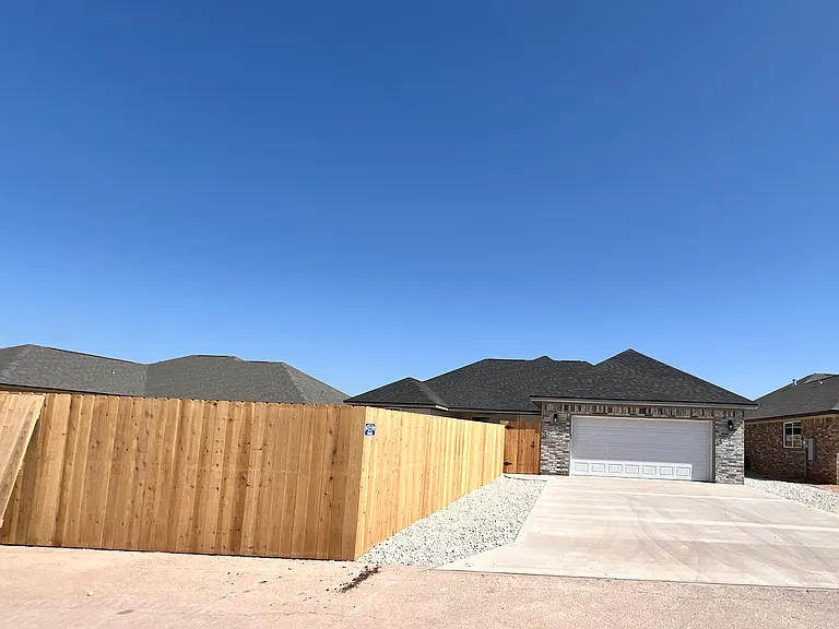 The back, alleyway, driveway, and fenced backyard
