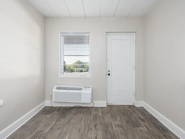 Experience comfort in this bright room with modern wood flooring.