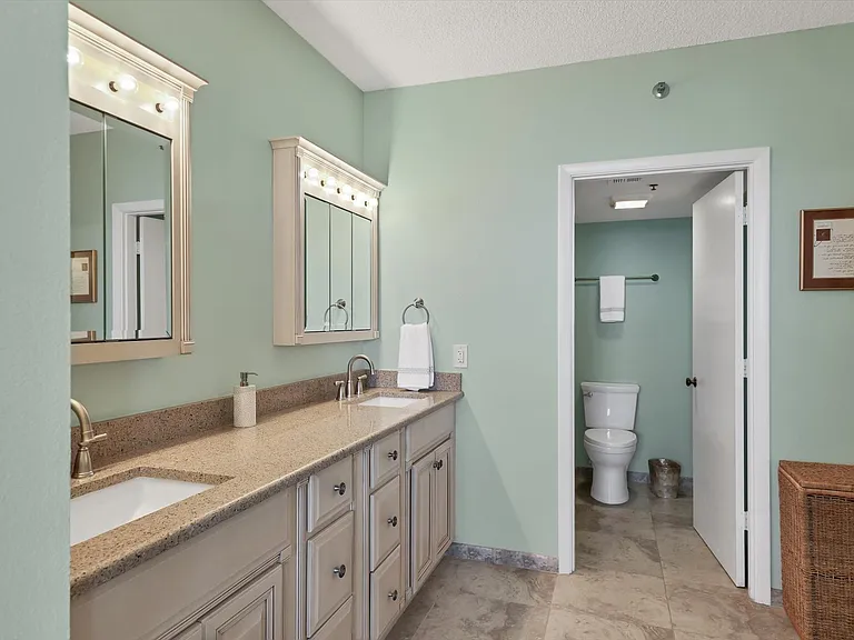 Primary suite bathroom with expansive sliding closet