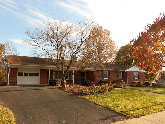 House front - level lot, wide driveway, garage