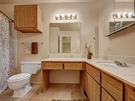 A large bathroom with a vanity and lots of cabinet space