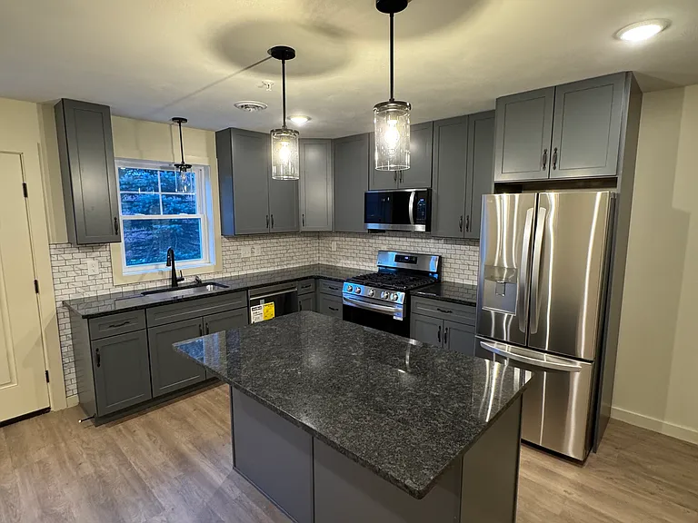 Large kitchen, new appliances, gas range, dishwasher, luxury granite countertop and island, tiled backsplash, garbage disposal, microwave range hood