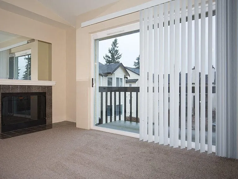 A Renovated 1 Bedroom 1 Bath Living Room with Fireplace at Brookhaven Apartments in Federal Way, Washington