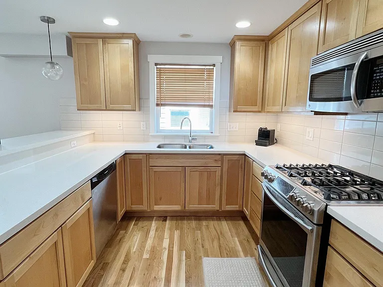 Quartz countertops, stainless steel appliances (including 5 burner gas stove) and double sink