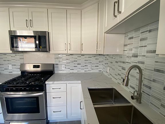 Exquisite quartz countertops and complimentary backsplash makes a statement.