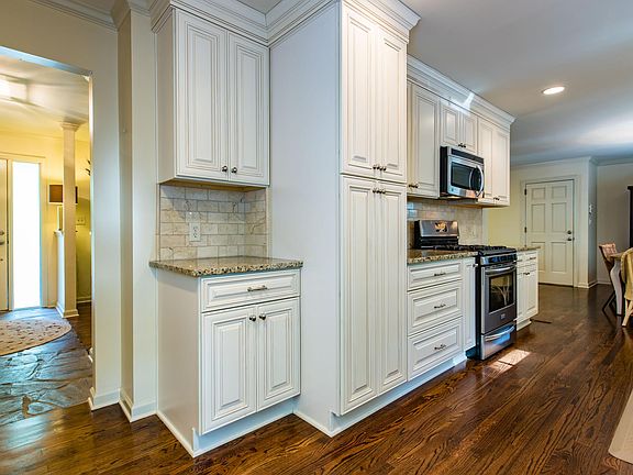 View from kitchen to front foyer and front door. Also shows view towards dining.