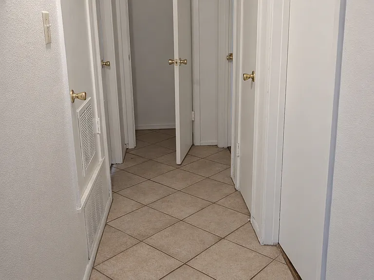 Hallway with 3 closets