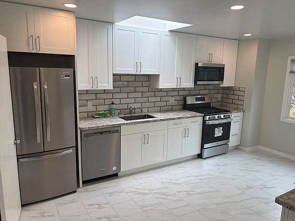 Remodeled kitchen with new appliances and recessed lighting