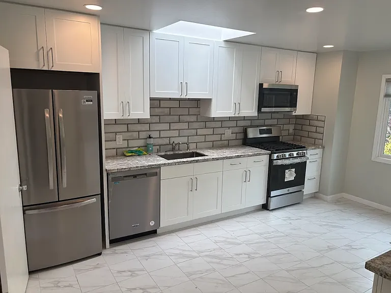 Remodeled kitchen with new appliances and recessed lighting