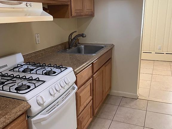 Pretty updated working kitchen has oak cabinets, a smaller oven/range and a full size refrigerator