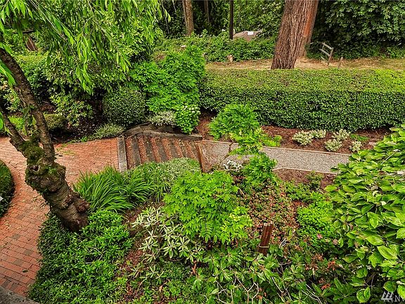 The brick walkways meander through the professionally landscaped gardens.