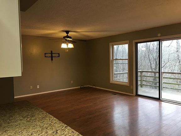 Living room with wood floors and view of back woods