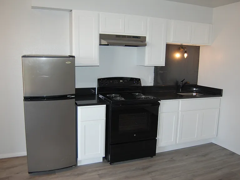New stainless steel backsplash behind the kitchen sink.