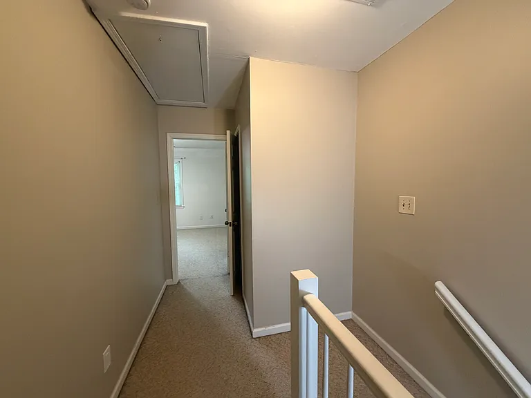 Hallway looking towards the back bedroom and linen closet