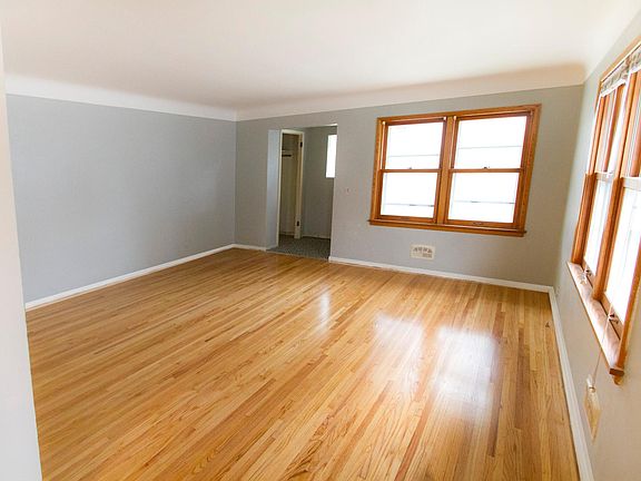 Living room with refinished hardwoods. South facing and full of sunlight.