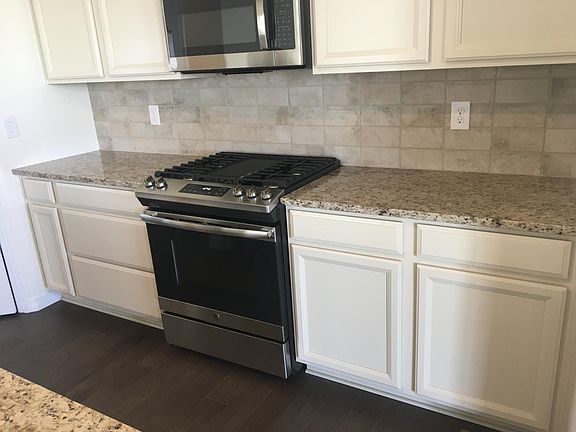 Kitchen w gas stove, microwave, refrigerator, dishwasher