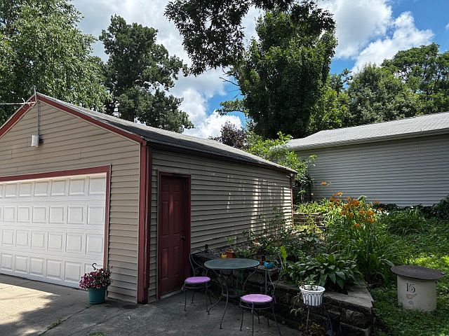 Two car shared garage and driveway, plus small garden and patio area