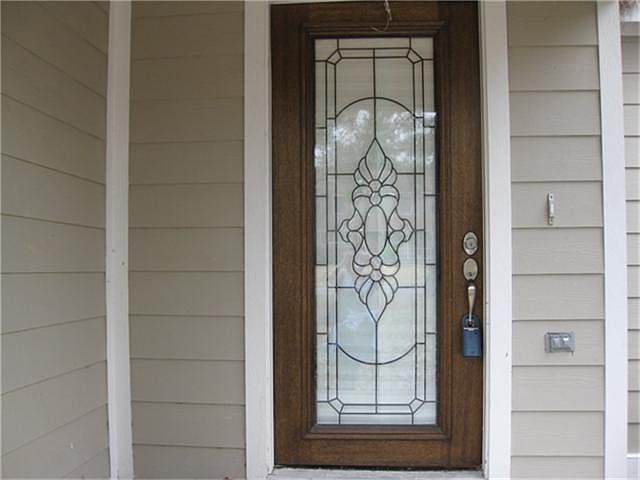 FRONT ENTRY-Beveled Front Door with wood trim, walking distance to a small park down the street with 5 major parks in the area.