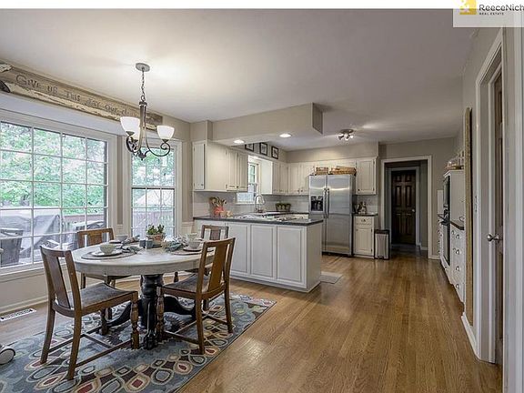 Eat-in and updated light-filled kitchen with walk-in pantry, half bath, and laundry room
