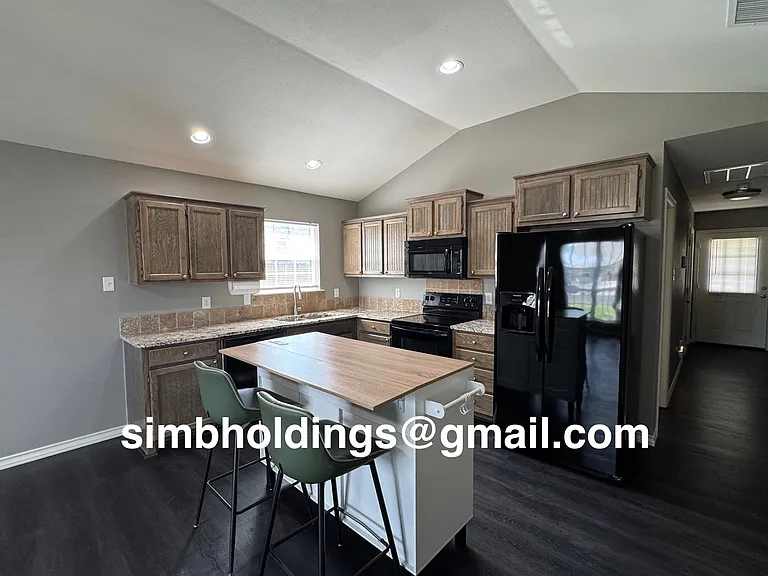 Kitchen includes island with a dining bar. Stools can be included if needed.