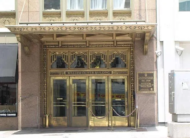 Canopy shelters the gorgeous Art Deco bronze doors serve as