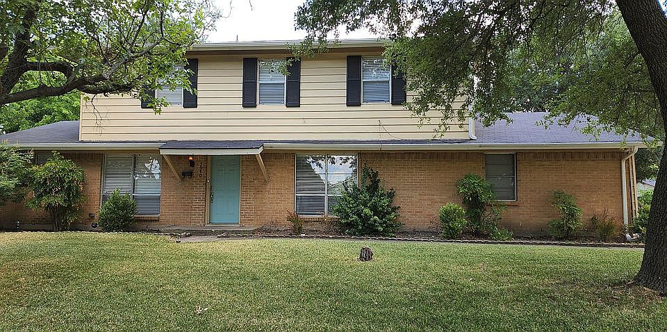 Shaded front yard with large Live Oaks.