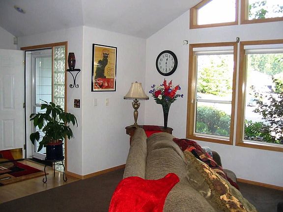 Hardwood floors and cathedral ceilings with wall on windows in Frml Living Rm