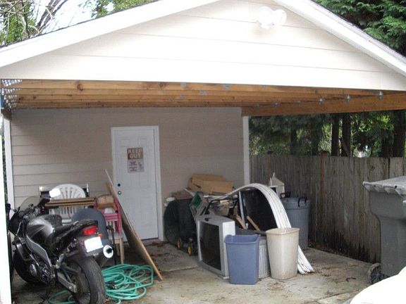 Storage Shed with covered entry provides additional storage.