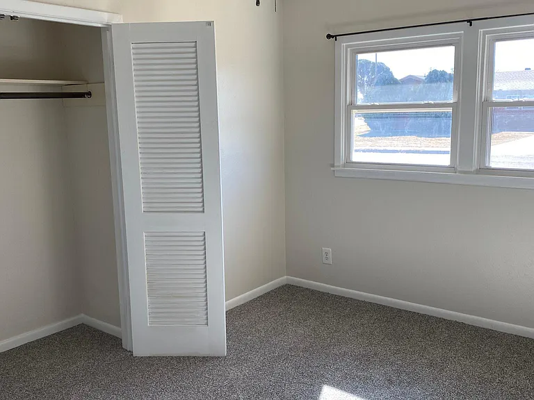Secondary bedroom. Custom paint, brand new carpet, large closet, and tons of natural light.