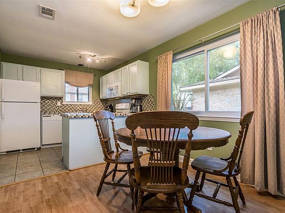 Natural light pours into an appealing dining area located off of the kitchen.