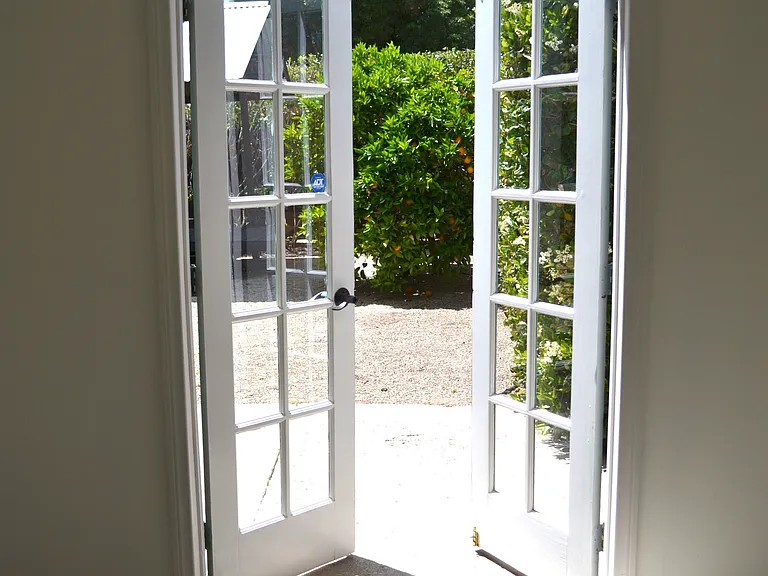 French doors from garage/workshop/studio open to garden.