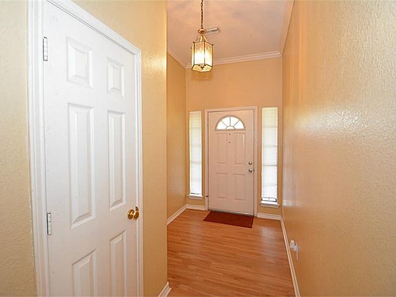 FRONT ENTRY WAY. WHOLE HOUSE HAS FRESH PAINT AND NEW LAMINATE FLOORING.
