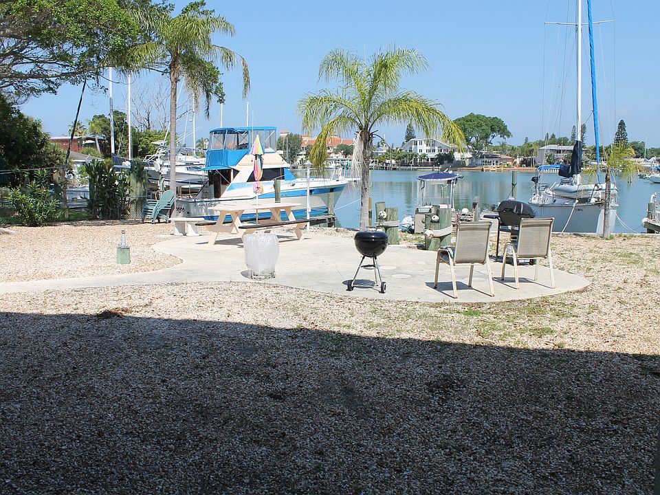 Waterfront common area with grill and picnic table