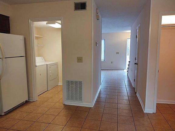 Main floor view to laundry room & brand new washer and dryer.