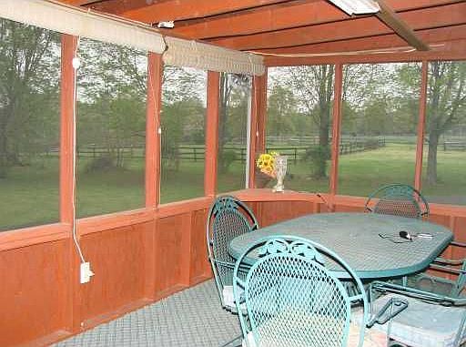 Enclosed porch overlooks the paddocks & peaceful woods