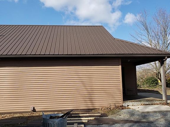 Parking area, shown while working on new roof. Entrance is through this porch.
