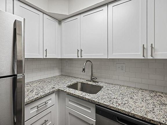 Experience culinary excellence in this sleek, modern kitchen.