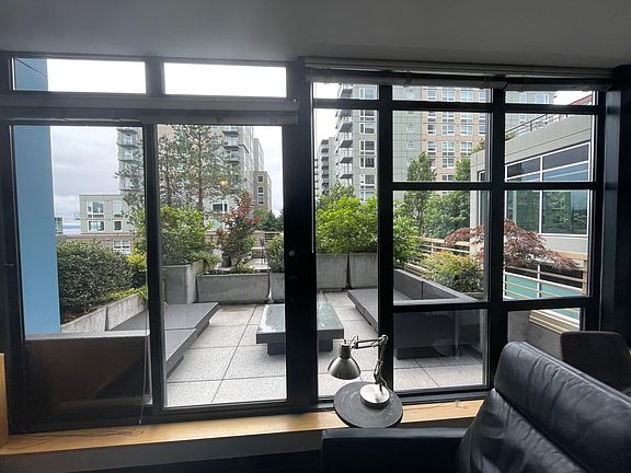14 ft x 14 ft private patio makes unit feel large and airy. All but 3 plants along the railing are maintained by condo association.