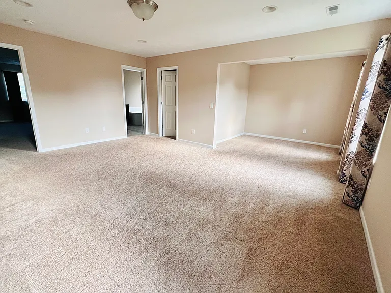 Primary suite with sitting area, walk-in closet and bathroom